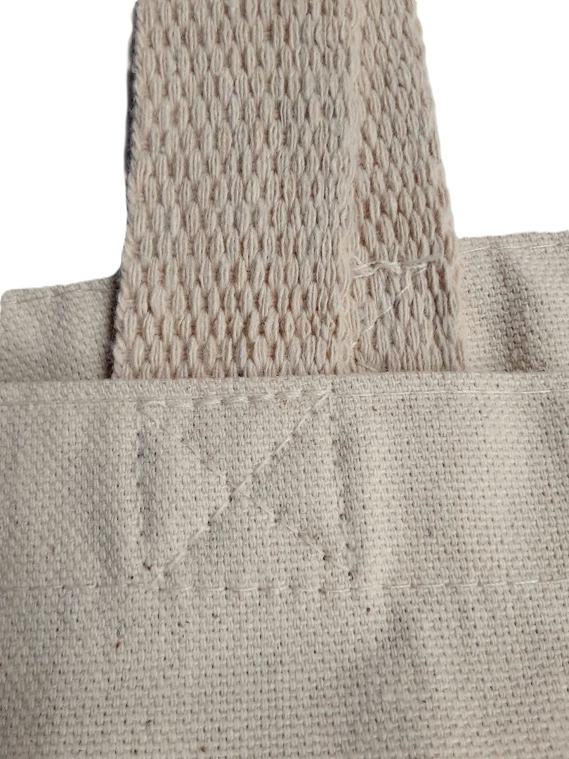 Photo of a tote canvas bag strong stitching.